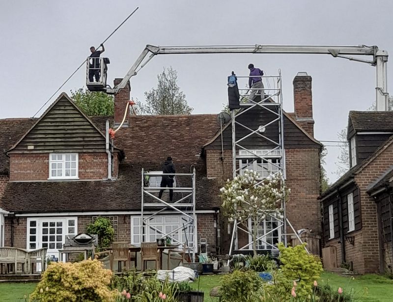 The Moss Cleaners using cherry picker and scaffolding to clean roof safely and professionally in Emsworth, Hampshire